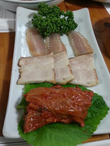 Fermented skate (홍어 hong uh) with pork belly (삼겹살 samgyeopsal)  and kimchi. I had no idea what this was at the time so I just ate it without any hesitation! A few of the other Korean graduate students from UC Berkeley told us that fermented skate is one of the dishes where your family either eats it or is repulsed by it. Since I was coming in with a clean slate, I have to say that it didn't taste so bad. I've never had fermented fish before and with the pork belly and super old kimchi, the taste isn't quite as strong as I would have though it to be. On its own though...it's not that bad either but the aftertaste becomes super pronounced. My mouth became numb (not in a bad way but like I ate an entire stick of mint candy) and that sensation of cooling numbness stuck in my mouth for a while. I definitely would eat it again!